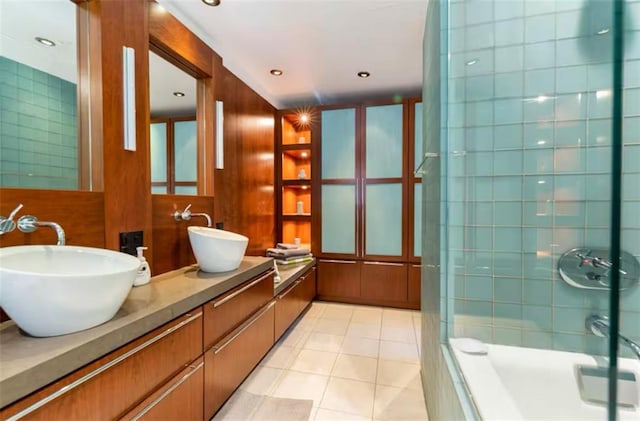 bathroom with tile patterned floors, tiled shower, and vanity