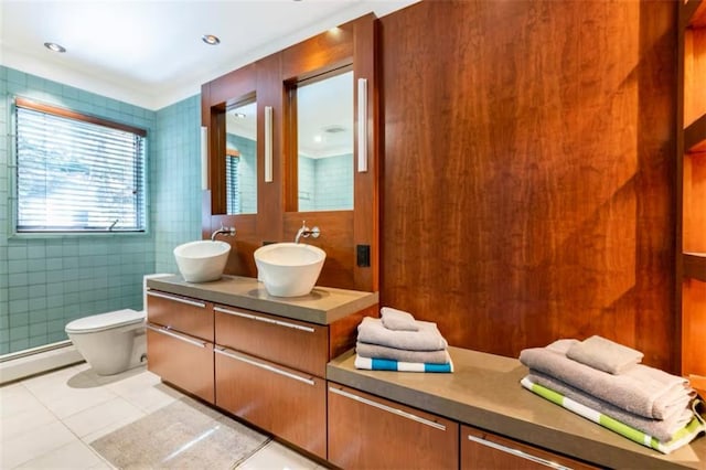 bathroom featuring tile patterned floors, a baseboard heating unit, toilet, tile walls, and vanity