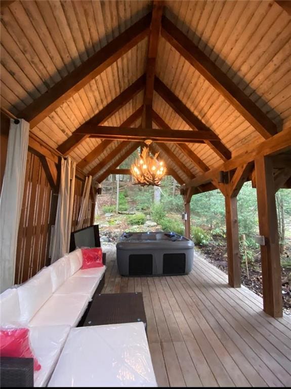 wooden terrace featuring a jacuzzi