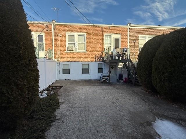 rear view of house featuring brick siding