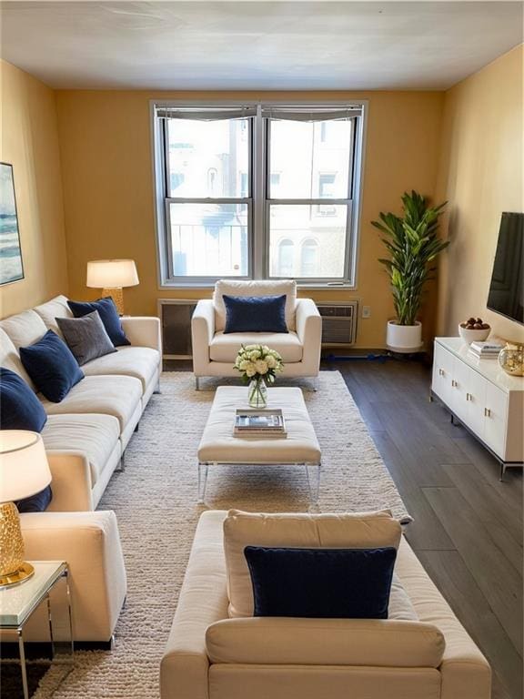 living room featuring a wall mounted air conditioner, dark hardwood / wood-style floors, and plenty of natural light