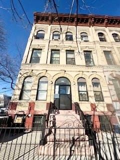 view of building exterior featuring a fenced front yard