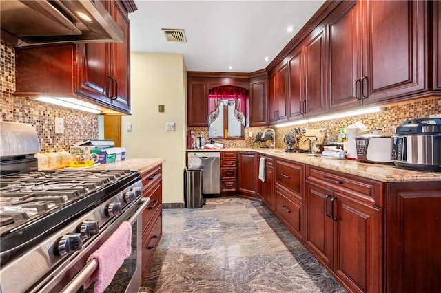 kitchen featuring stainless steel appliances, wall chimney range hood, and reddish brown cabinets