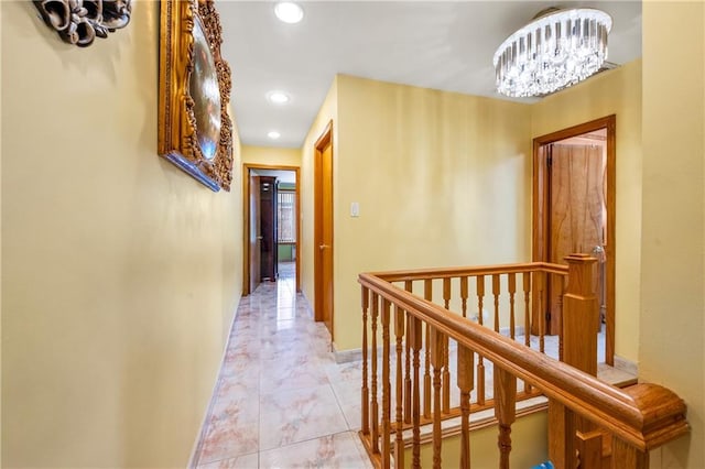 corridor featuring an upstairs landing, recessed lighting, baseboards, and an inviting chandelier