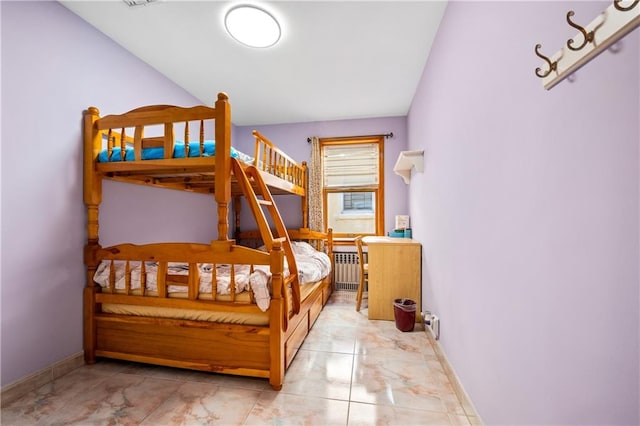 bedroom with baseboards and radiator heating unit