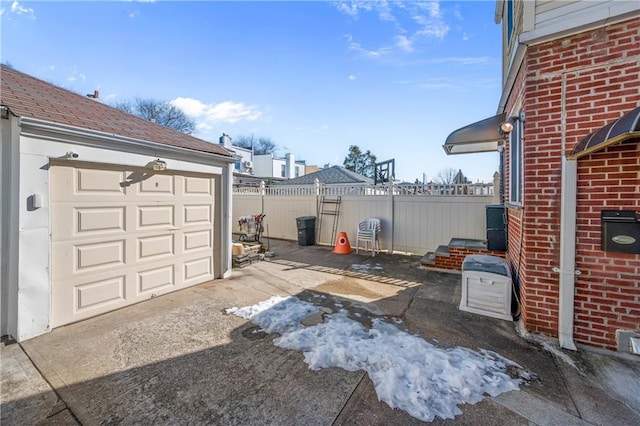 exterior space featuring fence, a garage, and driveway