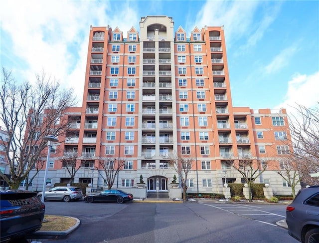 view of building exterior featuring uncovered parking