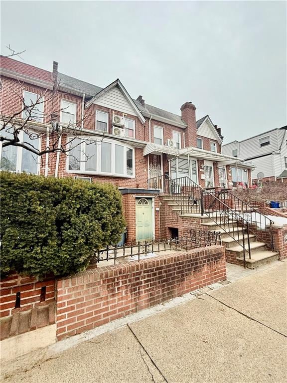 townhome / multi-family property featuring brick siding and a residential view