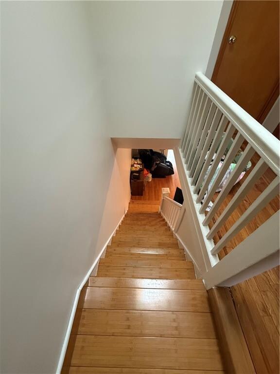 stairway featuring hardwood / wood-style flooring