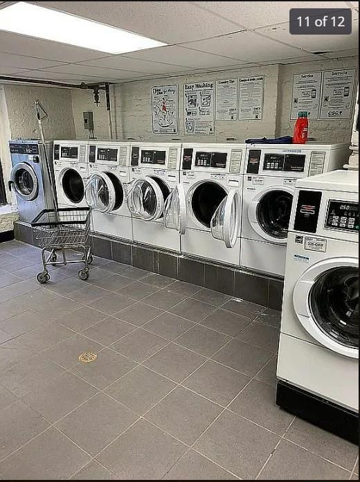 washroom featuring dark tile patterned floors and separate washer and dryer