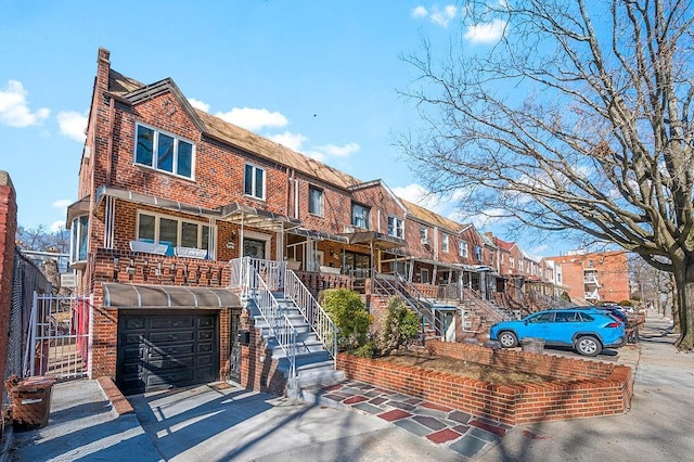 multi unit property featuring brick siding and driveway