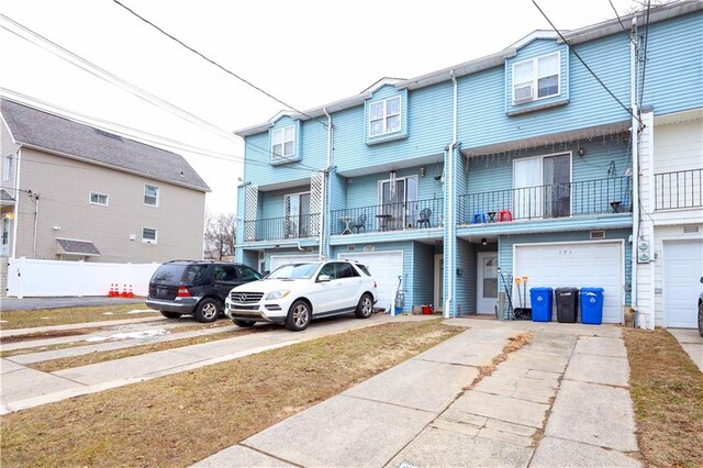 townhome / multi-family property featuring a garage and driveway