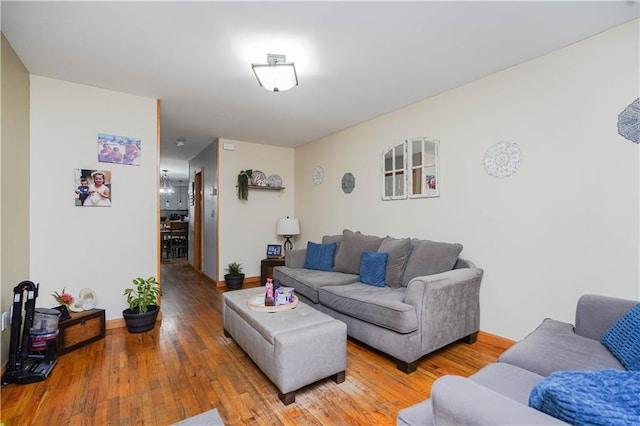 living area featuring baseboards and wood finished floors