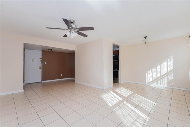 tiled spare room with ceiling fan