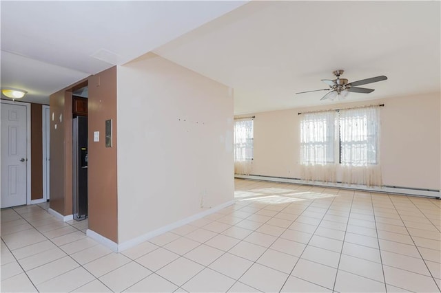 tiled empty room with a baseboard radiator and ceiling fan