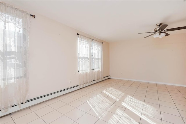 empty room featuring a baseboard heating unit, ceiling fan, and light tile patterned flooring