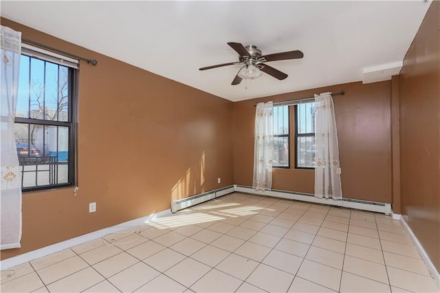 spare room featuring light tile patterned flooring, ceiling fan, and baseboard heating