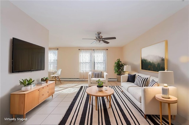 living room featuring light tile patterned flooring, ceiling fan, and a baseboard heating unit