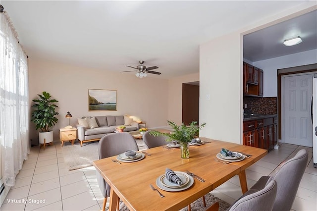 dining room with light tile patterned floors and ceiling fan