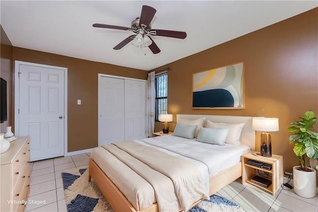 bedroom with light tile patterned floors, ceiling fan, and a closet