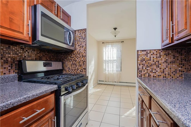 kitchen featuring light tile patterned floors, backsplash, a baseboard radiator, and appliances with stainless steel finishes