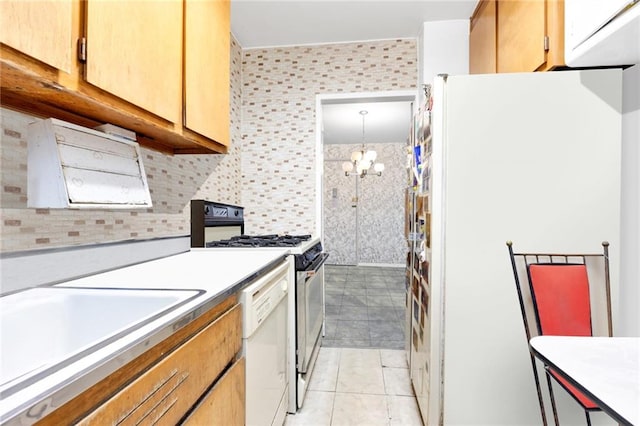 kitchen with decorative light fixtures, an inviting chandelier, white appliances, light tile patterned flooring, and decorative backsplash