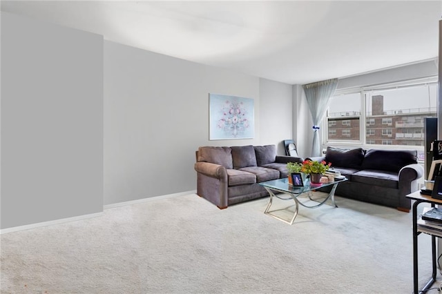 carpeted living room with baseboards