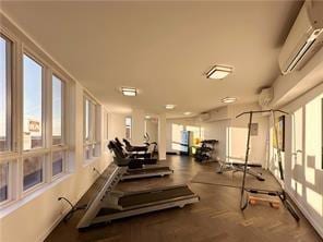 workout area featuring a wall unit AC