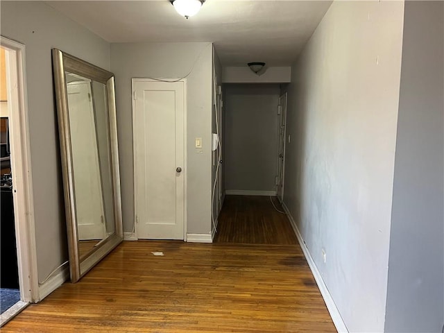 hall featuring wood finished floors and baseboards