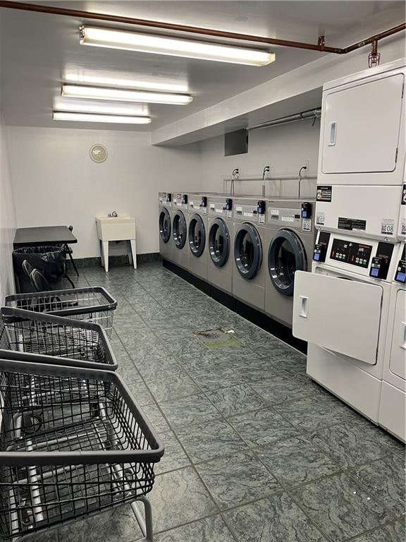 shared laundry area featuring stacked washer / dryer