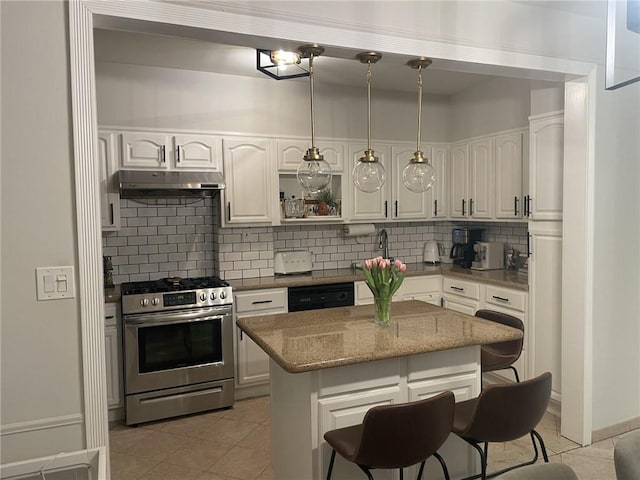 kitchen with white cabinetry, hanging light fixtures, a kitchen island, backsplash, and stainless steel gas range