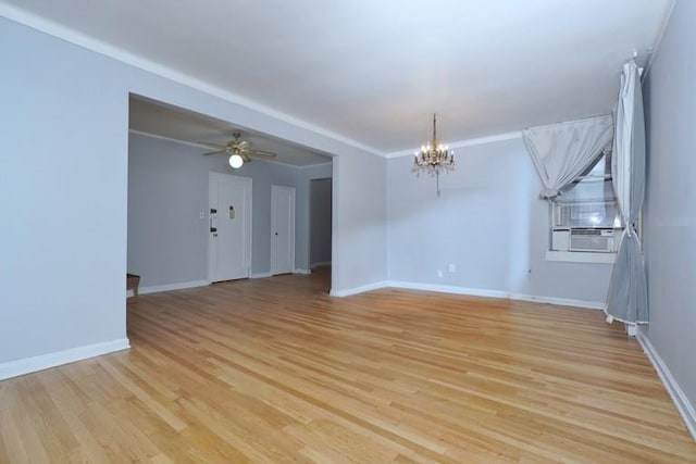 spare room with cooling unit, ceiling fan with notable chandelier, light wood-style flooring, and baseboards