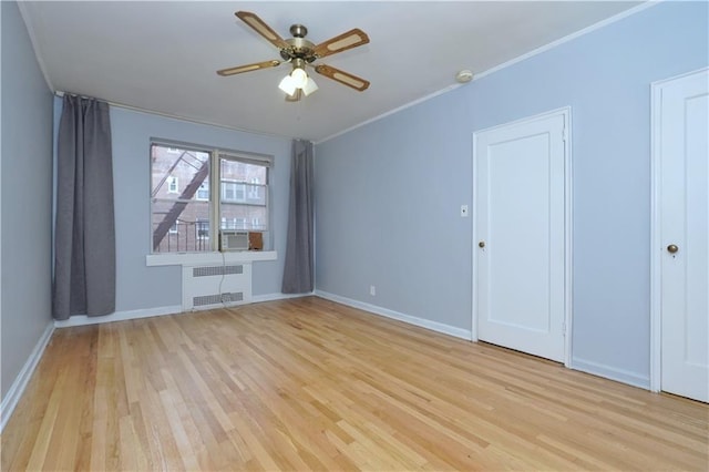 unfurnished room with radiator, light wood-style floors, ceiling fan, baseboards, and ornamental molding
