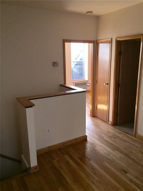 interior space featuring radiator heating unit and wood-type flooring