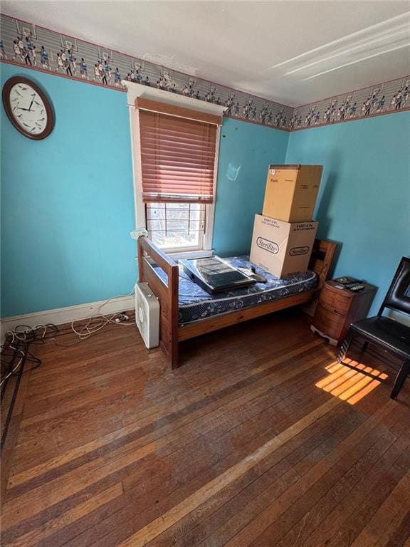 bedroom with dark hardwood / wood-style floors