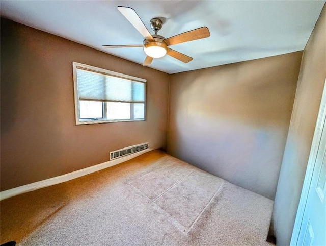 unfurnished room featuring ceiling fan and light carpet