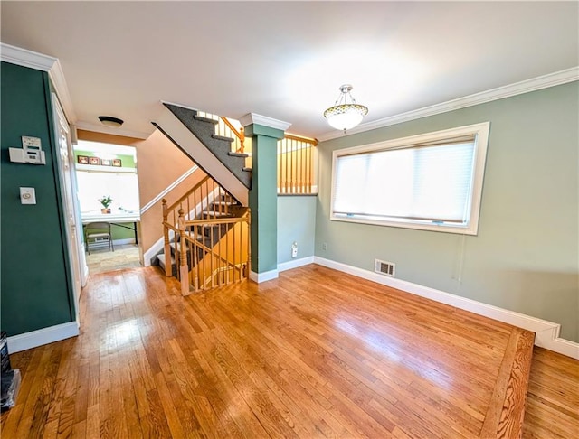 unfurnished room with hardwood / wood-style flooring and crown molding