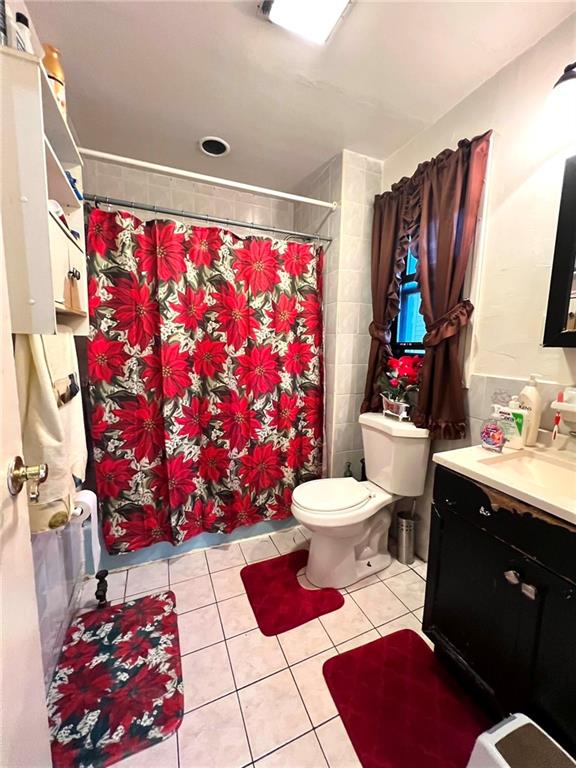 622 Ocean View Ave, Brooklyn, NY 11235 - full bathroom featuring toilet, curtained shower, tile patterned flooring, and vanity