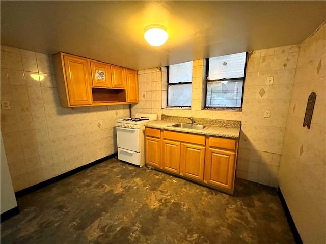 kitchen featuring white gas range and sink