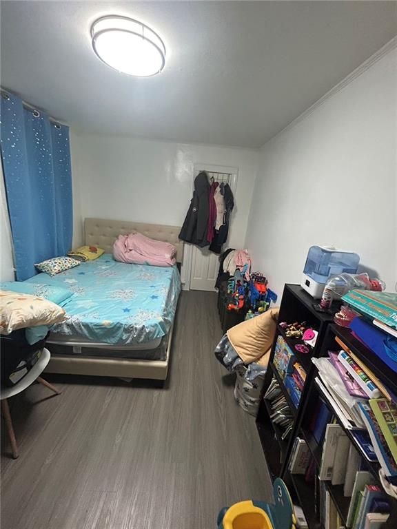 bedroom with dark wood-type flooring