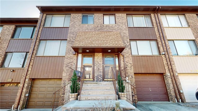 view of front of home with a garage and brick siding