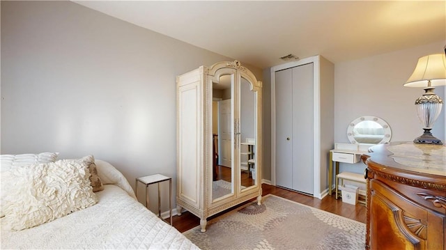 bedroom featuring hardwood / wood-style flooring and a closet