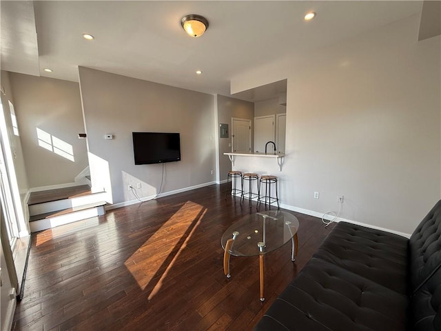 living area with recessed lighting, stairway, baseboards, and dark wood-style flooring