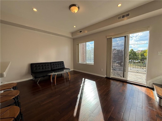 sitting room featuring recessed lighting, a healthy amount of sunlight, baseboards, and wood finished floors