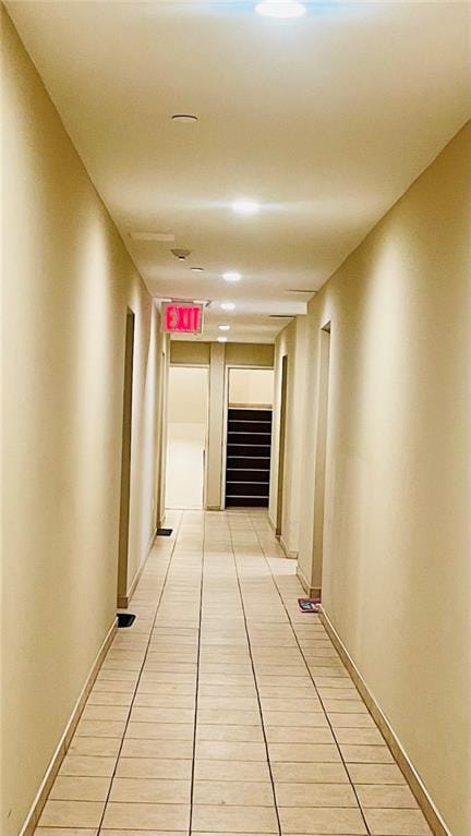 corridor featuring light tile patterned floors