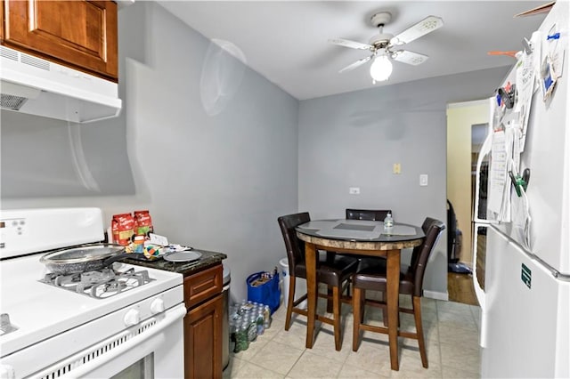 tiled dining room with ceiling fan