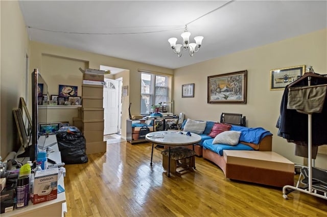 living room with an inviting chandelier and wood-type flooring