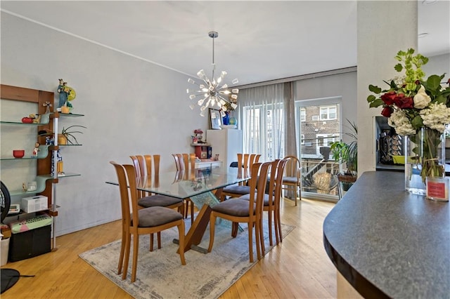 dining room featuring a notable chandelier and light wood-type flooring