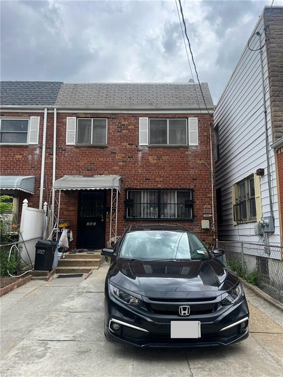 multi unit property featuring brick siding and fence