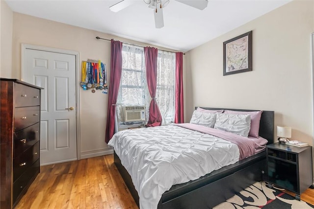 bedroom with light wood finished floors and a ceiling fan